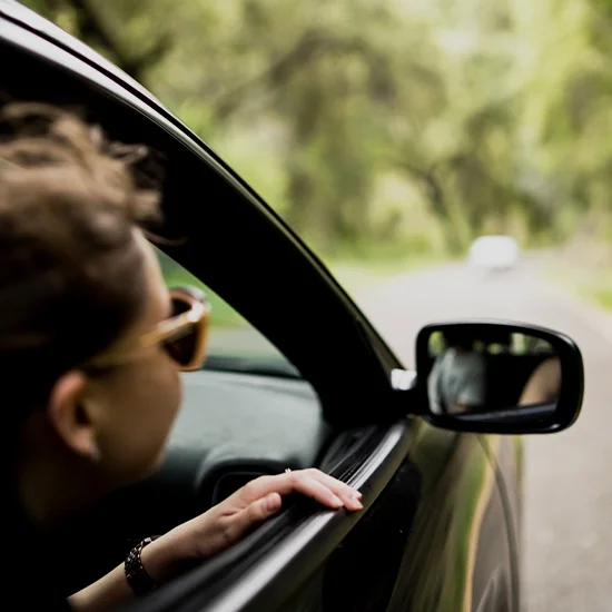 Person looking out of car window