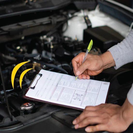 person checking a list by a car engine