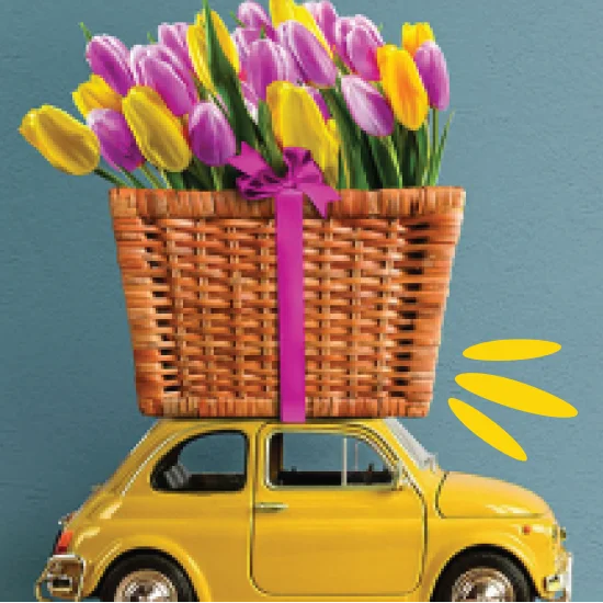 Yellow retro toy car with tulips on top