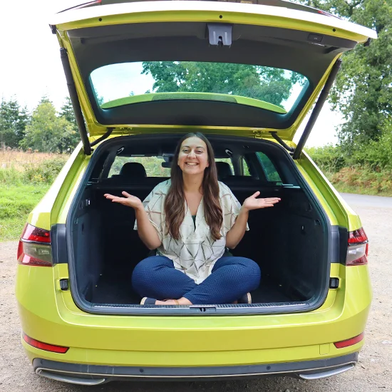 Woman sat in boot of Skoda Superb