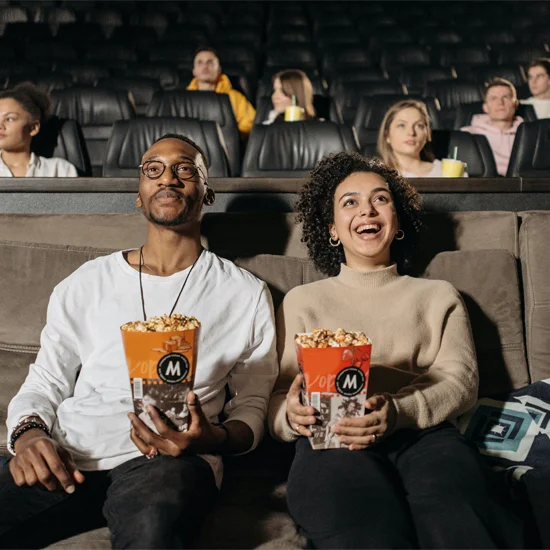 Couple watching film with popcorn