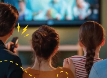 An image of a family watching TV together