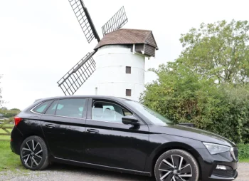 Skoda Scala parked next to windmill