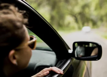 Person looking out of car window