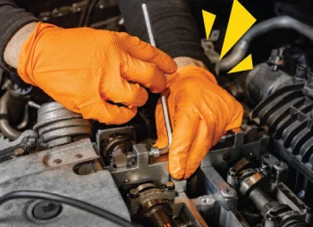 Close up of mechanic hands fixing an engine