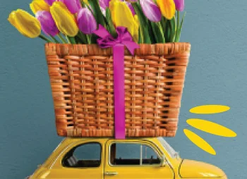 Yellow retro toy car with tulips on top