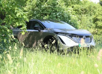 Nissan Ariya parked under tree