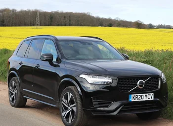 Volvo XC90 parked in front of fields