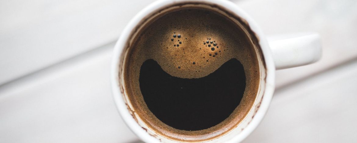 Strong black cup of coffee on a white table