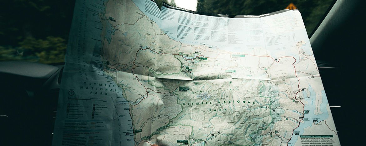 holding up a map in a car