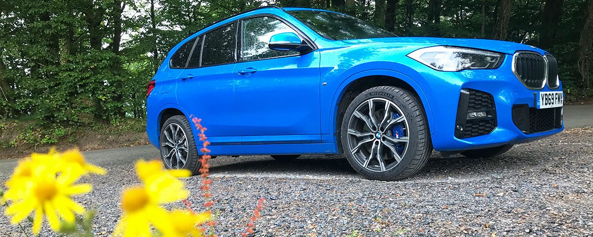 BMW X1 behind flowers