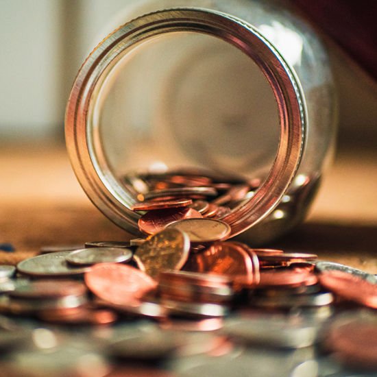 overturned-money-bank-spilling-coins-listing