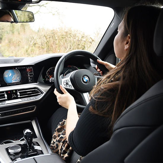 Woman behind steering wheel