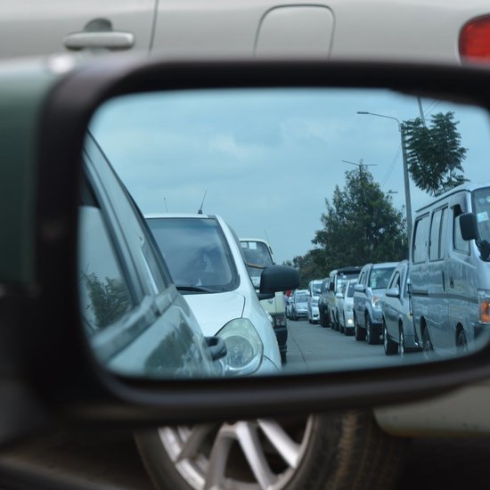 cars in a traffic jam, viewed through a wing mirror