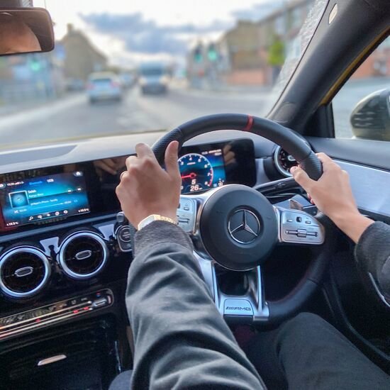 A person holding a Mercedes-Benz Wheel